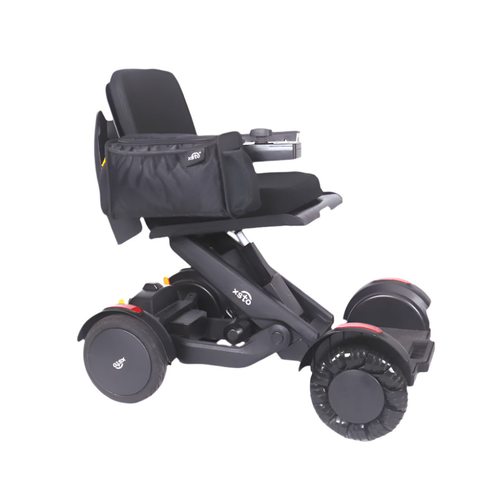 black bag on the side of electric wheelchair showing four wheels xsto m4 