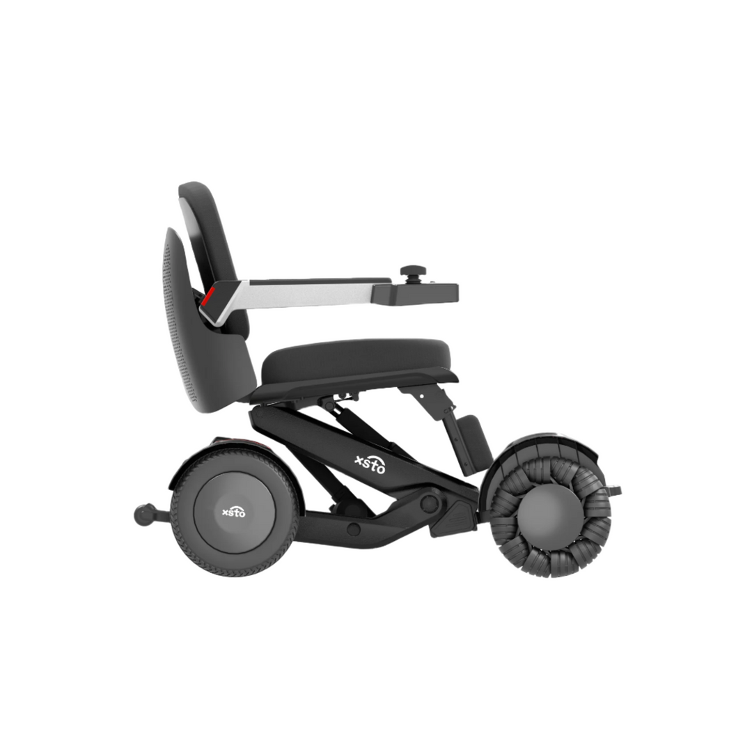 M4 Electric Wheelchair - by XSTO side low seat view showing wheels frame arm rest down